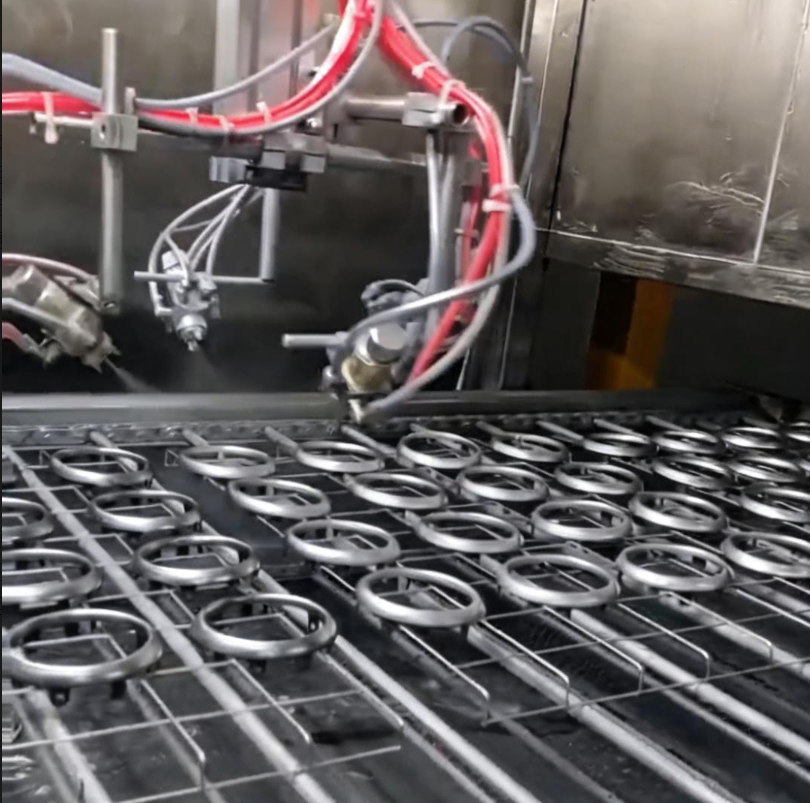 Spraying equipment processing circular components at Ningbo Jianlin.