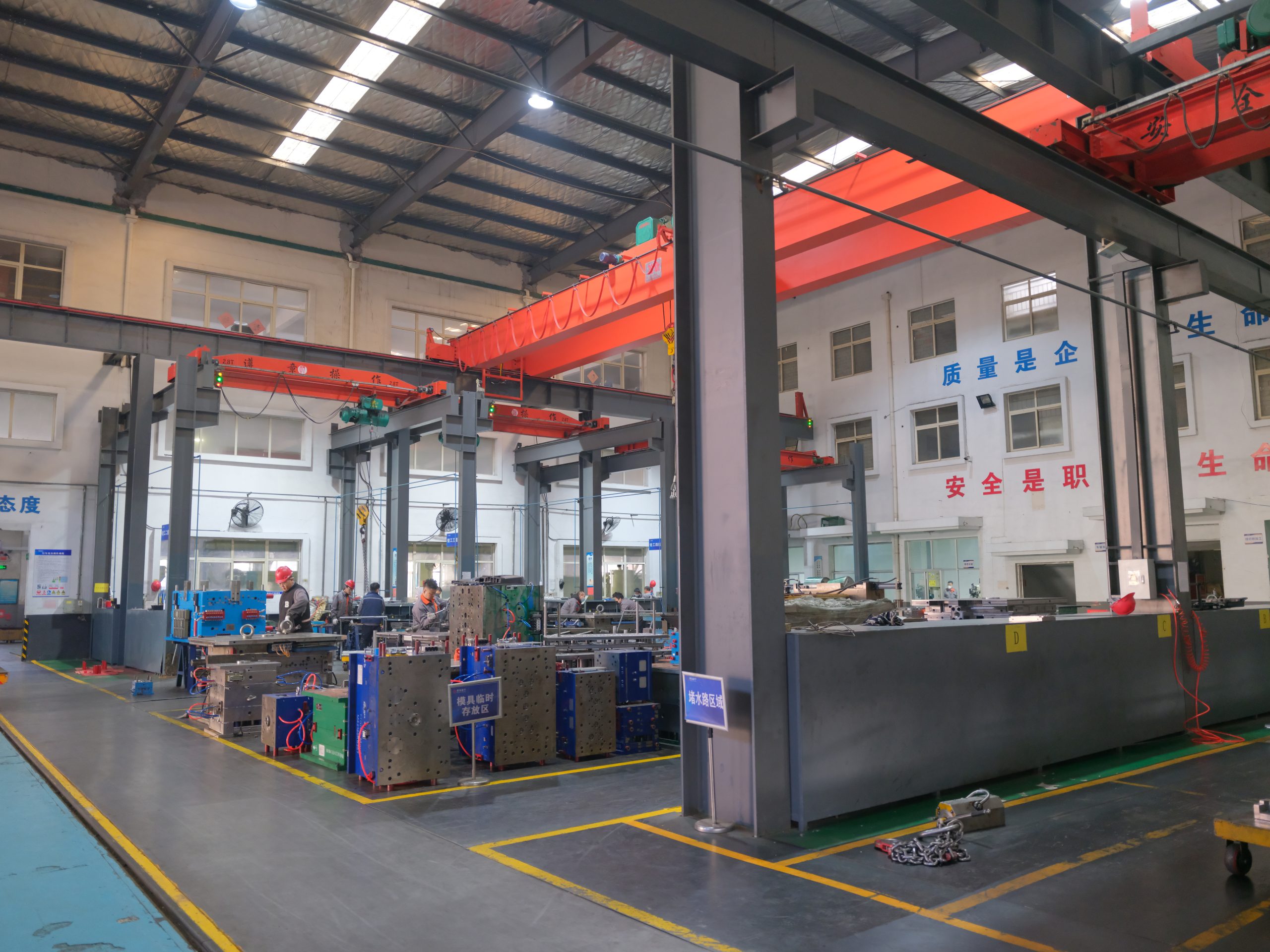 Bench fitting and mold assembly area inside Qingdao Jinning factory.
